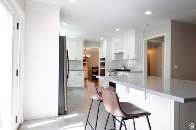 11089 S Justin Dr, Sandy, UT 84092 - kitchen with appliances with stainless steel finishes, backsplash, white cabinets, and recessed lighting