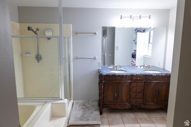 11089 S Justin Dr, Sandy, UT 84092 - bathroom featuring a shower stall, double vanity, tiled bath, and tile patterned flooring