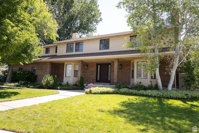 11089 S Justin Dr, Sandy, UT 84092 - traditional-style house featuring a front yard, brick siding, a chimney, and a porch