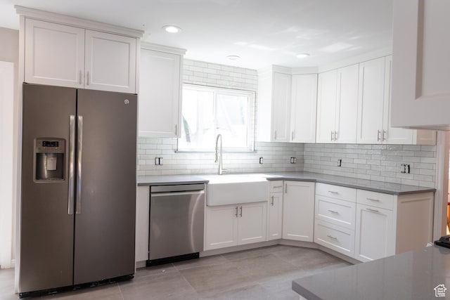 11089 S Justin Dr, Sandy, UT 84092 - kitchen featuring stainless steel appliances, white cabinets, tasteful backsplash, recessed lighting, and light tile patterned flooring