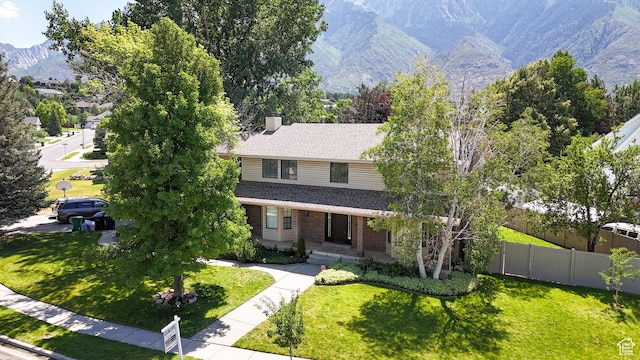 11089 S Justin Dr, Sandy, UT 84092 - view of front of home featuring a mountain view, brick siding, a chimney, and a shingled roof
