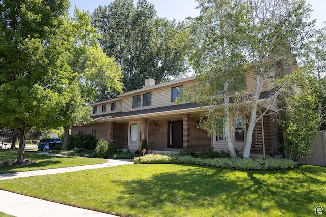 11089 S Justin Dr, Sandy, UT 84092 - traditional-style home featuring a front yard, brick siding, and a chimney