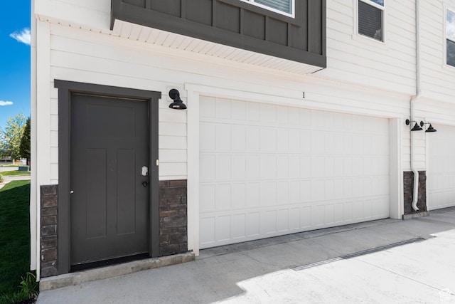 130 W Seasons Loop Upper, Upper, Garden City, UT 84028 - entrance to property featuring stone siding and an attached garage