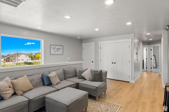 130 W Seasons Loop Upper, Upper, Garden City, UT 84028 - living area featuring light wood finished floors, recessed lighting, and a textured ceiling
