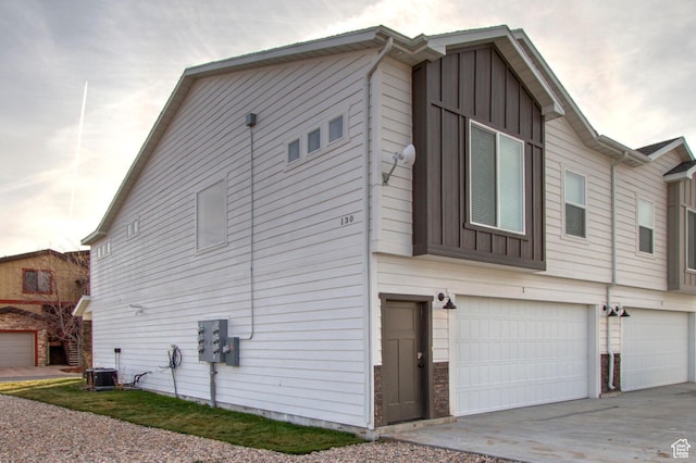 130 W Seasons Loop Upper, Upper, Garden City, UT 84028 - view of side of property with board and batten siding, concrete driveway, and a garage