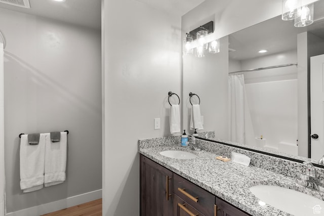 130 W Seasons Loop Upper, Upper, Garden City, UT 84028 - bathroom with double vanity, wood finished floors, a shower with shower curtain, and recessed lighting
