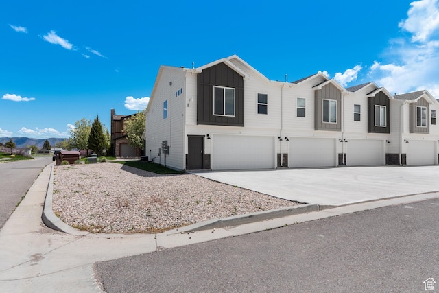 130 W Seasons Loop Upper, Upper, Garden City, UT 84028 - view of front of property with board and batten siding, an attached garage, and driveway