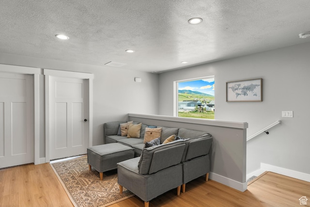 130 W Seasons Loop Upper, Upper, Garden City, UT 84028 - living room with a textured ceiling, light wood-type flooring, and recessed lighting