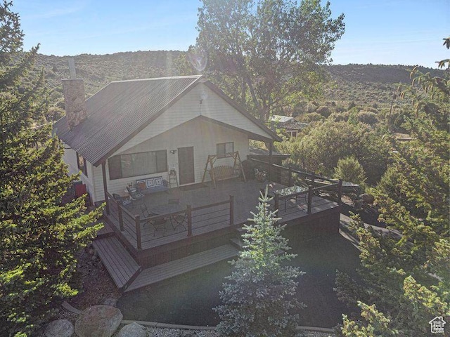 214 S Terry Pkwy, Pine Valley, UT 84781 - rear view of property featuring a chimney and a wooden deck