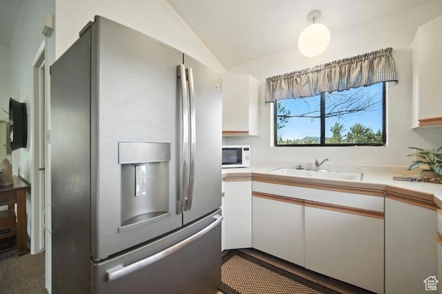 214 S Terry Pkwy, Pine Valley, UT 84781 - kitchen featuring stainless steel refrigerator with ice dispenser, white cabinets, vaulted ceiling, light countertops, and white microwave