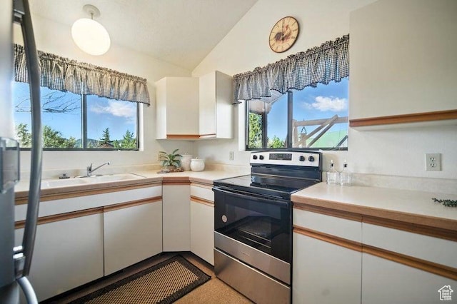 214 S Terry Pkwy, Pine Valley, UT 84781 - kitchen with stainless steel electric stove, lofted ceiling, light countertops, and white cabinetry