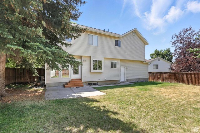 1298 Eastridge Cir, Logan, UT 84321 - back of house featuring entry steps, a fenced backyard, and a patio area