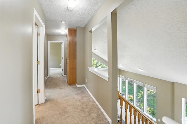 1298 Eastridge Cir, Logan, UT 84321 - corridor featuring a textured ceiling and light carpet