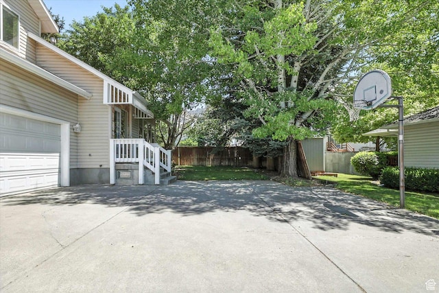 1298 Eastridge Cir, Logan, UT 84321 - view of patio featuring concrete driveway and a garage