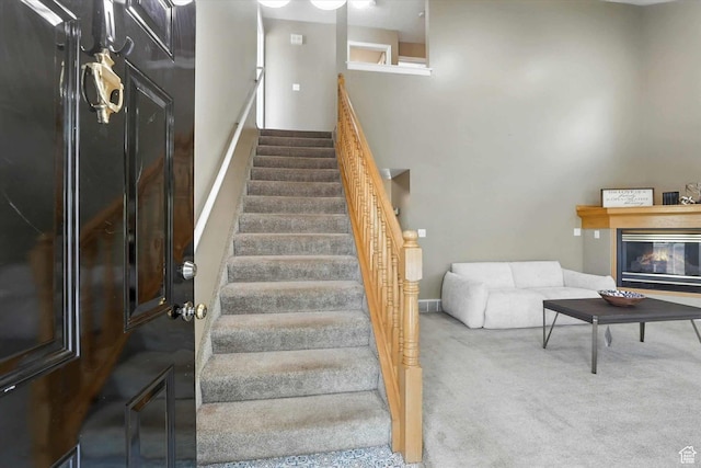 1298 Eastridge Cir, Logan, UT 84321 - stairway featuring carpet floors and a glass covered fireplace