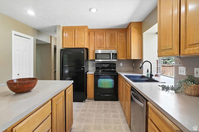 1298 Eastridge Cir, Logan, UT 84321 - kitchen with black appliances, light countertops, a textured ceiling, recessed lighting, and brown cabinetry
