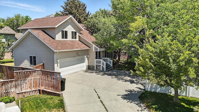 1298 Eastridge Cir, Logan, UT 84321 - view of side of property with a shingled roof, driveway, and an attached garage