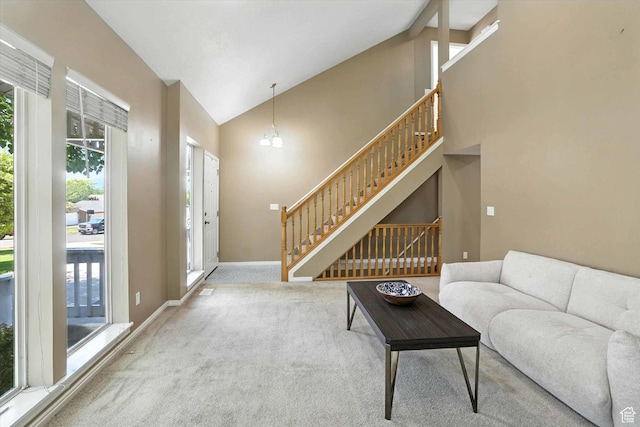 1298 Eastridge Cir, Logan, UT 84321 - living room with carpet floors, high vaulted ceiling, and stairs