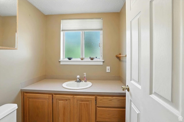 1298 Eastridge Cir, Logan, UT 84321 - half bath featuring vanity and a textured ceiling