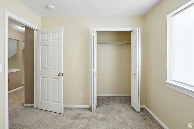 1298 Eastridge Cir, Logan, UT 84321 - unfurnished bedroom featuring carpet flooring, a closet, and a textured ceiling
