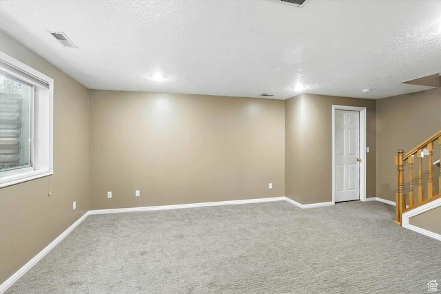 1298 Eastridge Cir, Logan, UT 84321 - finished below grade area featuring stairway, carpet flooring, and a textured ceiling