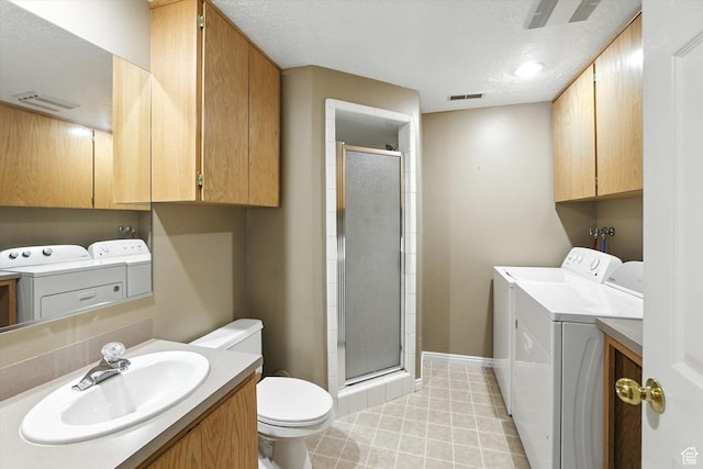 1298 Eastridge Cir, Logan, UT 84321 - bathroom featuring washing machine and clothes dryer, a stall shower, vanity, and a textured ceiling