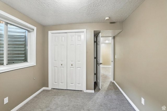 1298 Eastridge Cir, Logan, UT 84321 - unfurnished bedroom featuring carpet flooring, a closet, and a textured ceiling