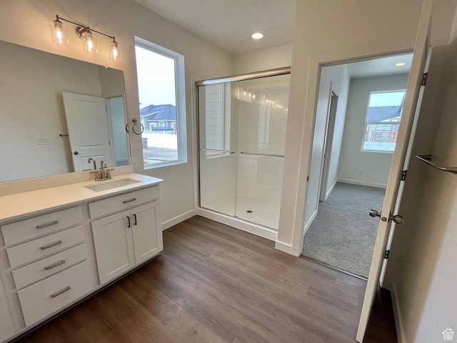 1170 E Blackfeet Dr Unit 502, Eagle Mountain, UT 84005 - bathroom featuring a shower stall, vanity, wood finished floors, and recessed lighting