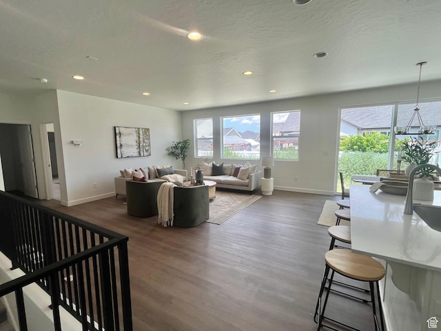 1170 E Blackfeet Dr Unit 502, Eagle Mountain, UT 84005 - living room featuring healthy amount of natural light, recessed lighting, and dark wood-type flooring
