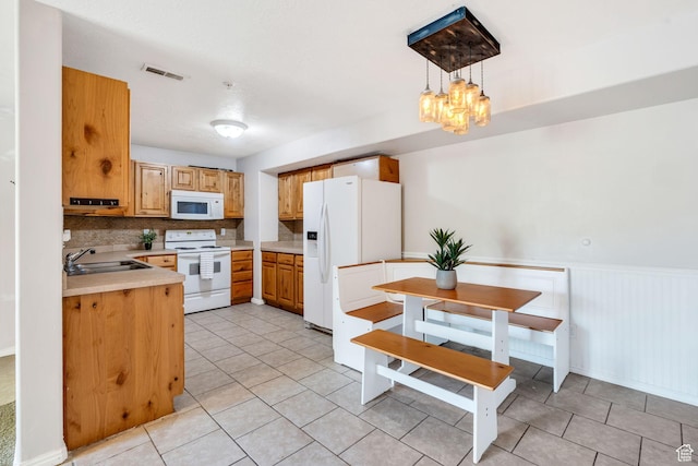 8246 N Cedar Springs Rd E Unit 8, Eagle Mountain, UT 84005 - kitchen featuring white appliances, light countertops, light tile patterned floors, backsplash, and a chandelier