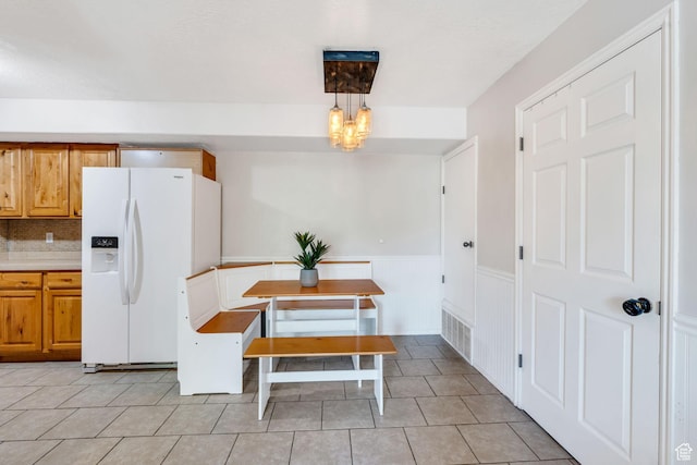 8246 N Cedar Springs Rd E Unit 8, Eagle Mountain, UT 84005 - dining room featuring a chandelier, wainscoting, and light tile patterned flooring
