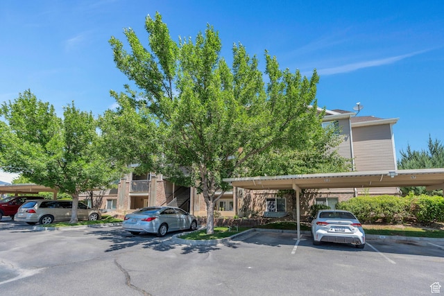 8246 N Cedar Springs Rd E Unit 8, Eagle Mountain, UT 84005 - view of property featuring covered and uncovered parking