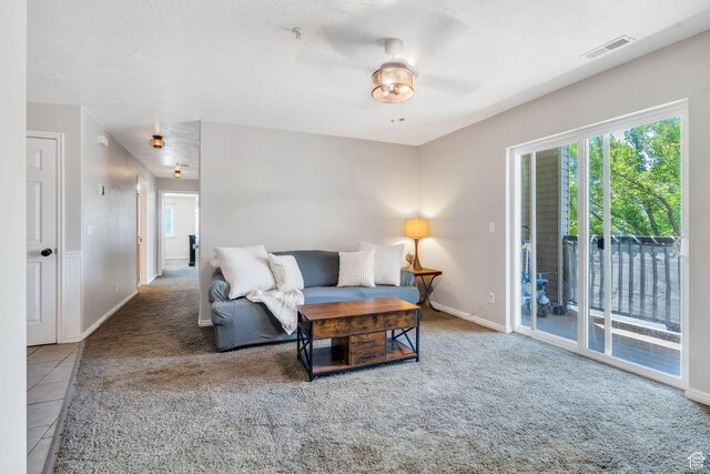 8246 N Cedar Springs Rd E Unit 8, Eagle Mountain, UT 84005 - living area with carpet floors, a ceiling fan, and a textured ceiling