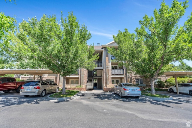 8246 N Cedar Springs Rd E Unit 8, Eagle Mountain, UT 84005 - view of front of property with covered parking, french doors, and brick siding