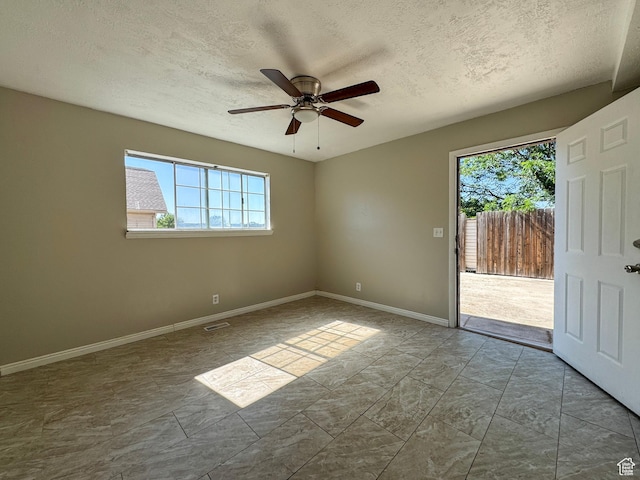 1790 W Homestead Farm Ln Unit 4, West Valley City, UT 84119 - empty room with a textured ceiling, ceiling fan, and marble finish floors