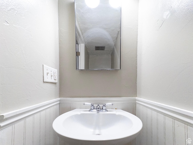 1790 W Homestead Farm Ln Unit 4, West Valley City, UT 84119 - bathroom with wainscoting and a decorative wall