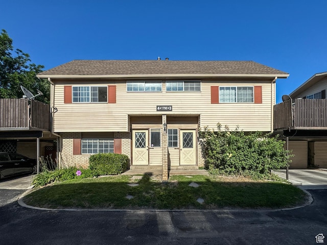 1790 W Homestead Farm Ln Unit 4, West Valley City, UT 84119 - view of front of home with brick siding and a shingled roof