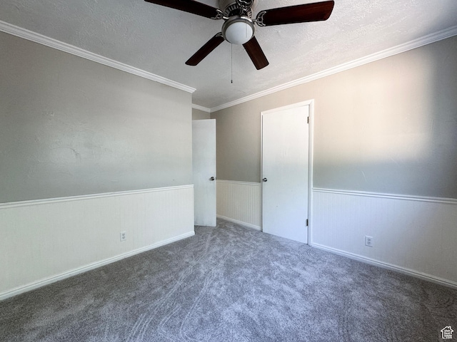 1790 W Homestead Farm Ln Unit 4, West Valley City, UT 84119 - spare room featuring a ceiling fan, a wainscoted wall, a textured ceiling, carpet flooring, and crown molding