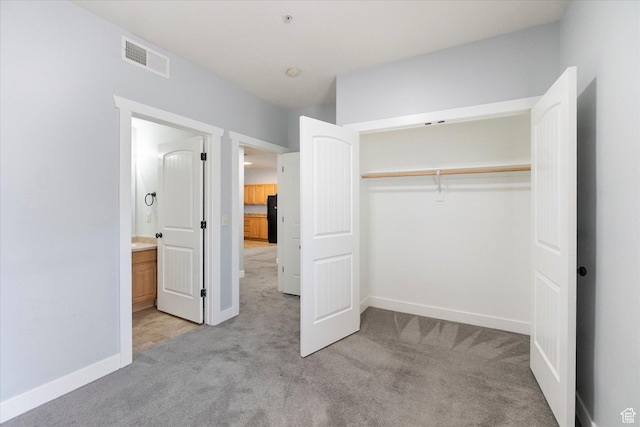 75 E 200 N Unit 206, Provo, UT 84606 - unfurnished bedroom featuring light colored carpet, a closet, freestanding refrigerator, and ensuite bathroom