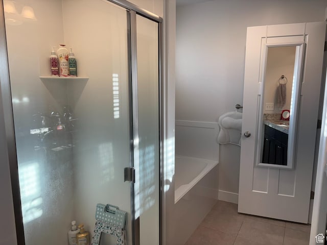 7579 N Cottage Ln, Eagle Mountain, UT 84005 - bathroom with tile patterned floors, a garden tub, vanity, and an enclosed shower