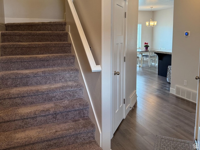 7579 N Cottage Ln, Eagle Mountain, UT 84005 - stairway with a chandelier and wood finished floors