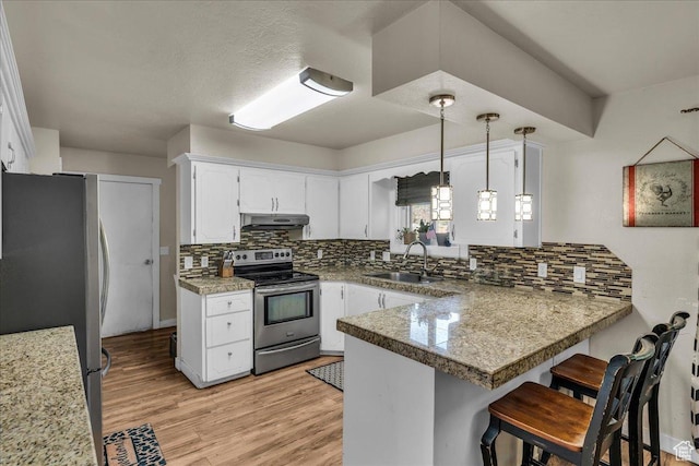 120 N Scenic Dr E, Washington, UT 84780 - kitchen with appliances with stainless steel finishes, a peninsula, white cabinetry, and tasteful backsplash