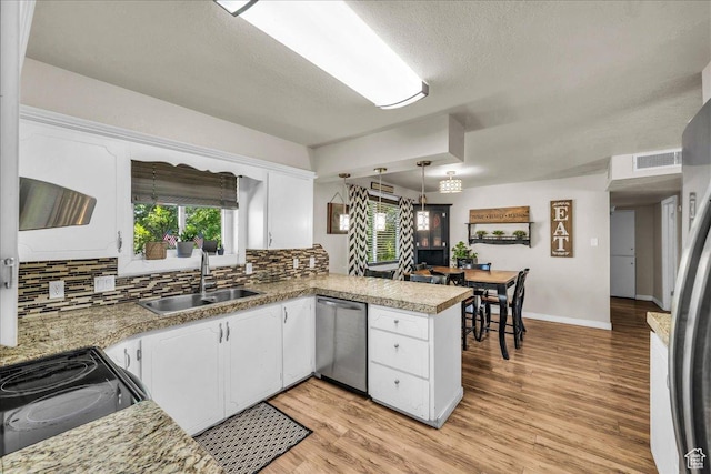 120 N Scenic Dr E, Washington, UT 84780 - kitchen featuring dishwasher, a peninsula, backsplash, white cabinetry, and electric range