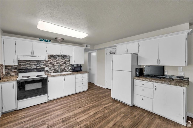 120 N Scenic Dr E, Washington, UT 84780 - kitchen featuring white appliances, under cabinet range hood, decorative backsplash, dark wood-style floors, and a textured ceiling