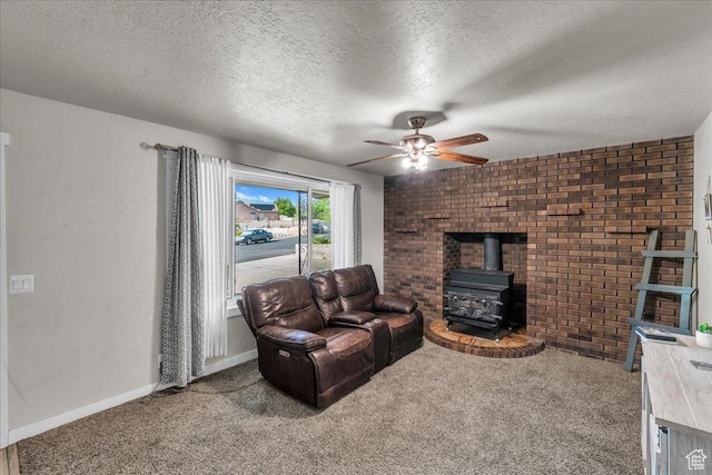120 N Scenic Dr E, Washington, UT 84780 - living room with a wood stove, a ceiling fan, carpet, a textured ceiling, and brick wall