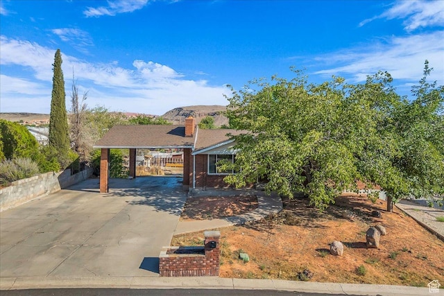 120 N Scenic Dr E, Washington, UT 84780 - view of front facade featuring a carport, driveway, and a chimney