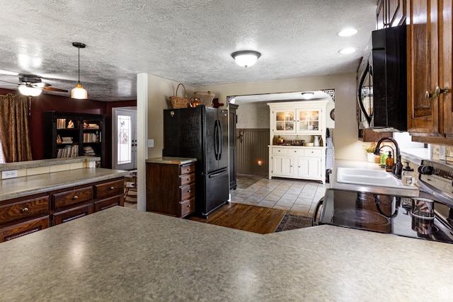 453 Sheridan Cir, Centerville, UT 84014 - kitchen with freestanding refrigerator, range with electric cooktop, dark wood-style flooring, hanging light fixtures, and a textured ceiling