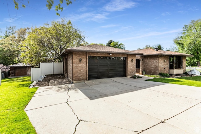 453 Sheridan Cir, Centerville, UT 84014 - ranch-style house with brick siding, an attached garage, and driveway