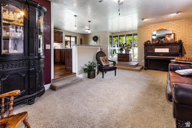 453 Sheridan Cir, Centerville, UT 84014 - living room with carpet, a textured ceiling, a ceiling fan, and brick wall