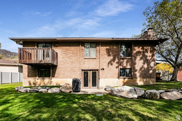 453 Sheridan Cir, Centerville, UT 84014 - back of property featuring a chimney, french doors, a balcony, and brick siding